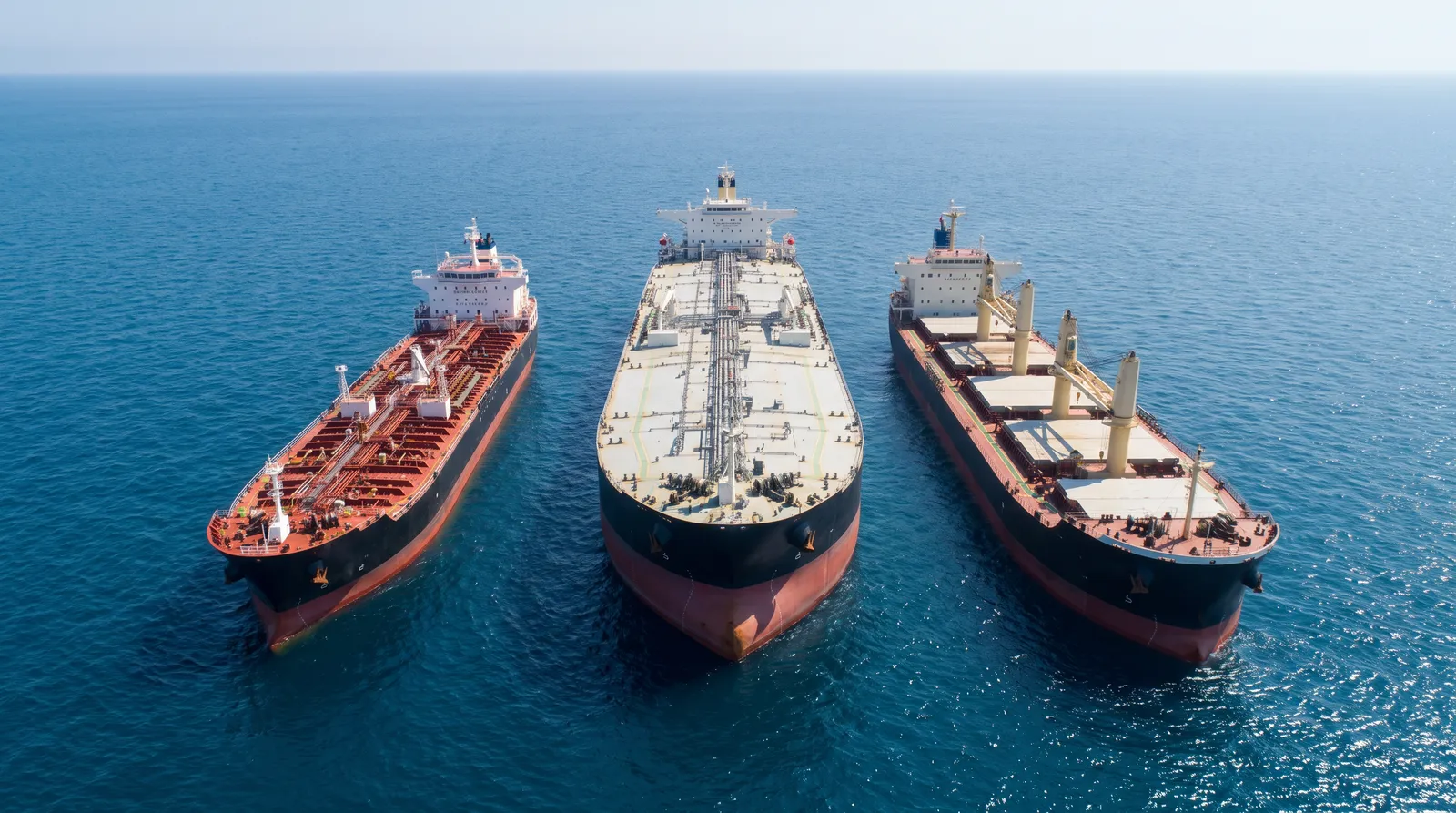Aerial view of an oil products tanker, a crude oil tanker and a bulk carrier sailing side by side